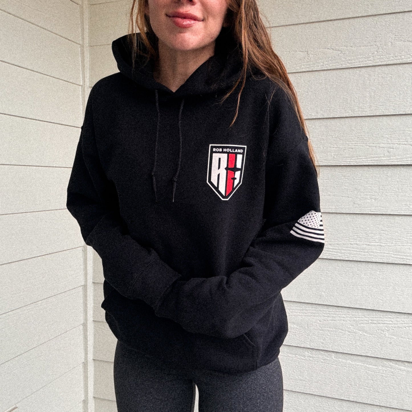 woman wearing a hooded black sweatshirt with Rob Holland Aerosports logo visible on the front