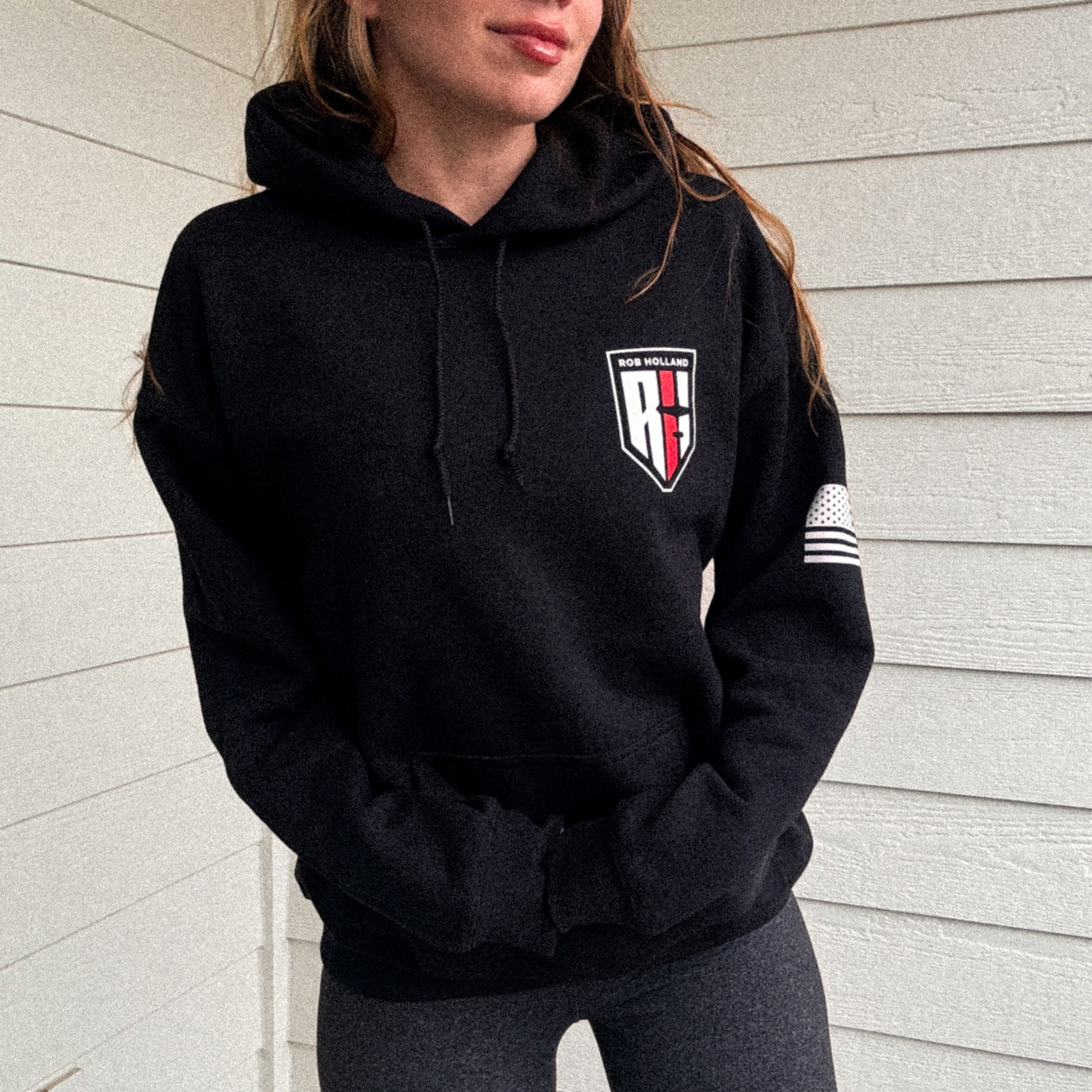 woman wearing a hooded black sweatshirt  with Rob Holland Aerosports logo visible on the front